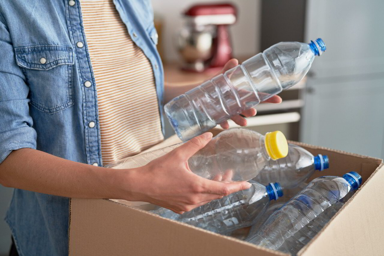 Sorting plastic bottles into a box for recycling